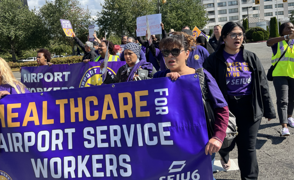 Sea-Tac airport workers rally in street for healthcare